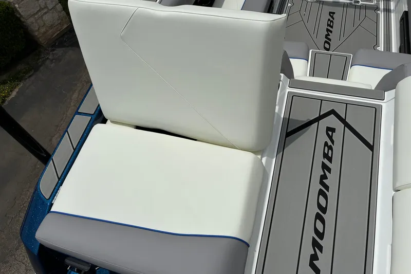 Slide: The Image of 2026 Moomba Tykon boat interior with white seating and branded flooring. - 14