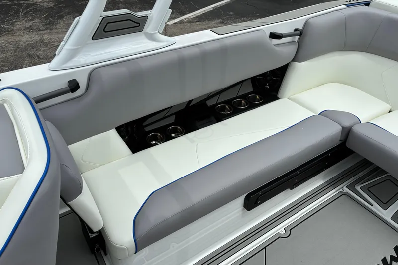 Slide: The Image of 2026 Moomba Tykon boat interior with gray and white seating and cup holders. - 19