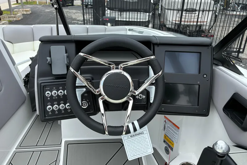Slide: The Image of 2026 Moomba Tykon boat dashboard with steering wheel and control panel. - 24
