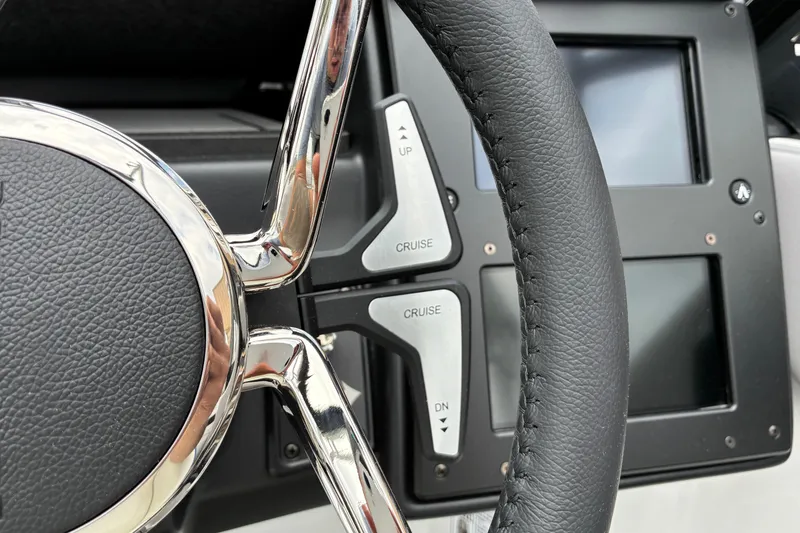 Slide: The Image of Steering wheel and controls of 2026 Moomba Tykon boat, featuring cruise settings. - 26