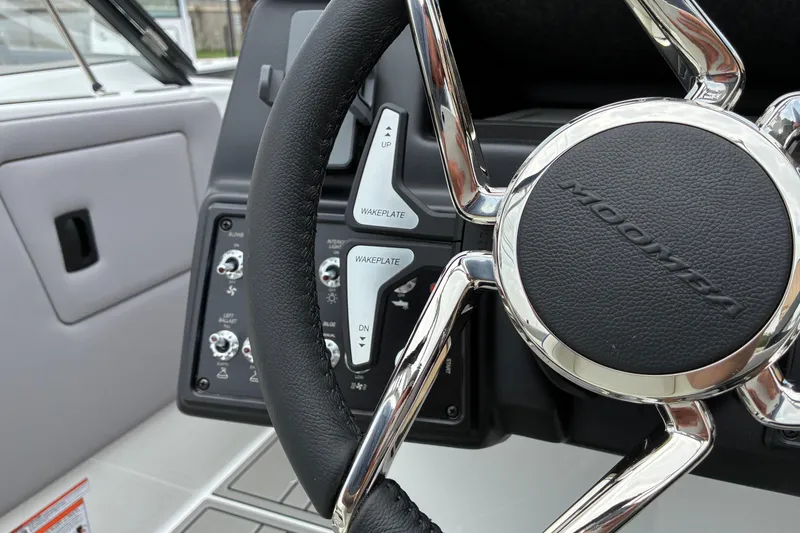 Slide: The Image of Steering wheel of 2026 Moomba Tykon boat with control panel details. - 27