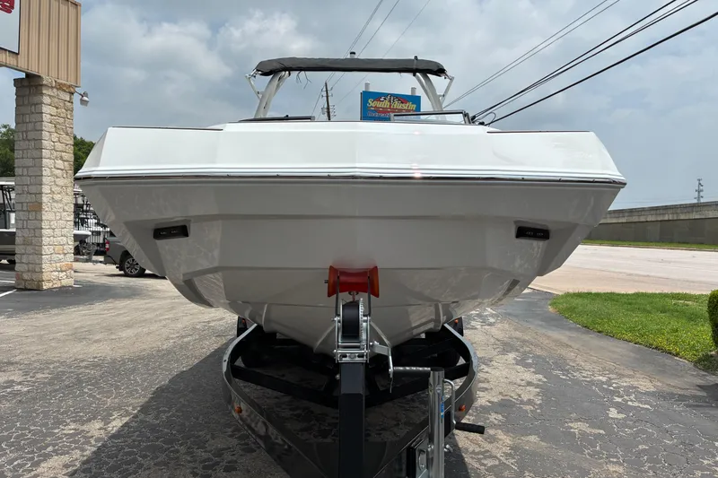 Slide: The Image of 2026 Moomba Tykon boat on trailer, front view, parked outdoors. - 3