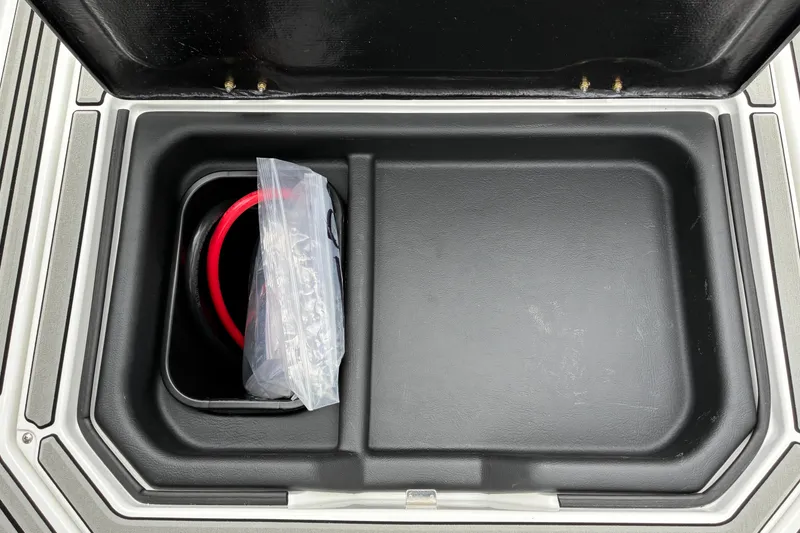 Slide: The Image of Storage compartment in 2026 Moomba Tykon boat with coiled red cable. - 31