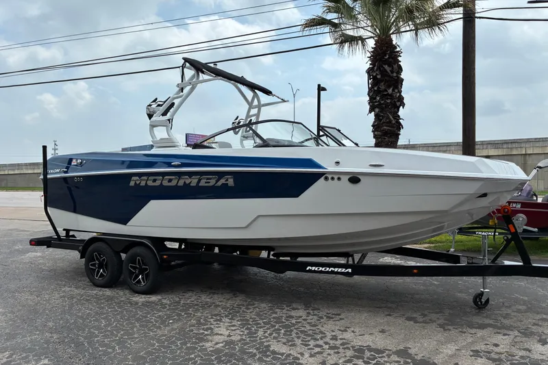 Slide: The Image of 2026 Moomba Tykon boat on trailer, parked outdoors under cloudy sky. - 33