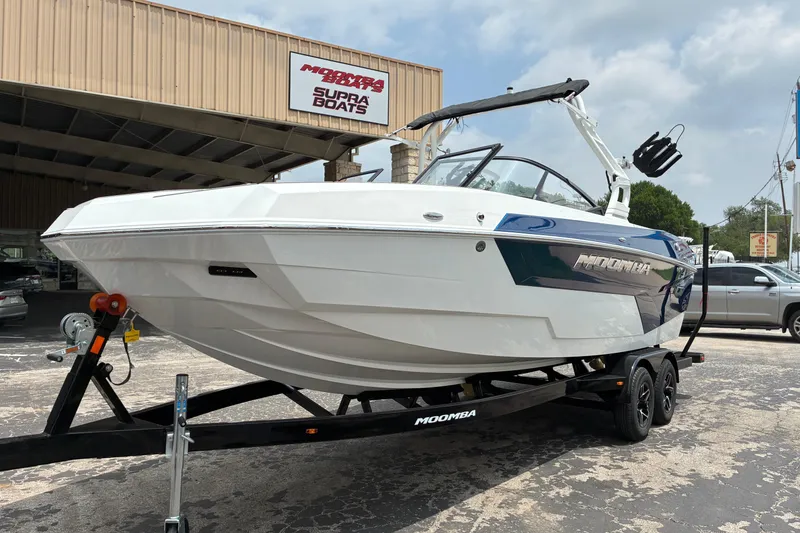 Slide: The Image of 2026 Moomba Tykon boat on trailer outside dealership, showcasing sleek design and modern features. - 4