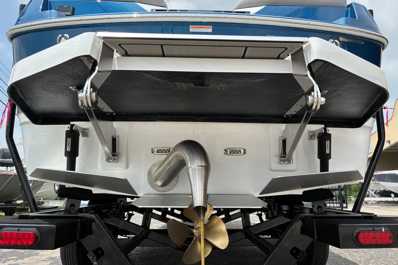 The Image of Rear view of 2026 Moomba Tykon boat, showcasing propeller and trim tabs. - 8