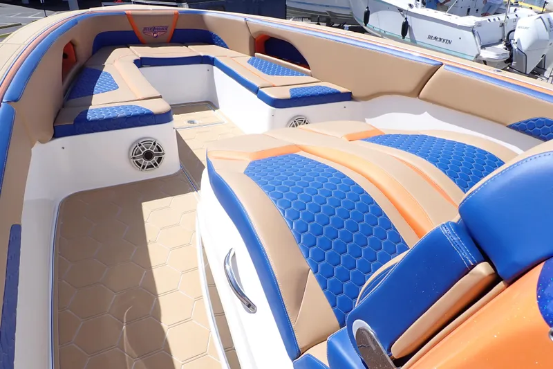 Slide: The Image of 2022 Deep Impact 369 Sport boat interior with blue and orange seating, hexagonal pattern. - 10