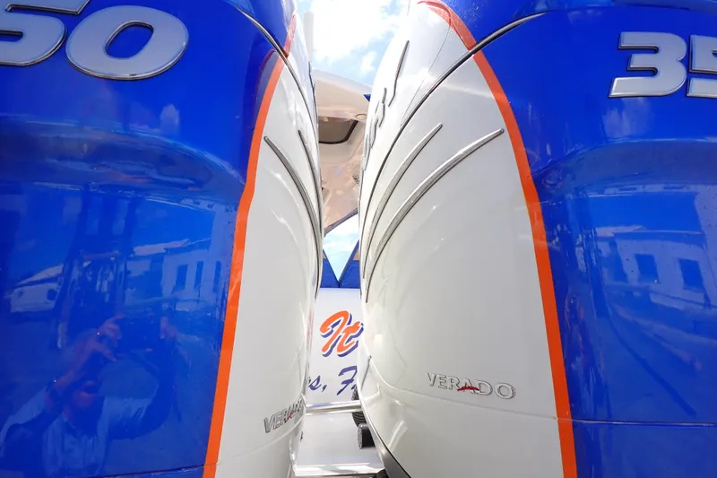 Slide: The Image of Twin Verado engines on a 2022 Deep Impact 369 Sport boat, blue and white design. - 100