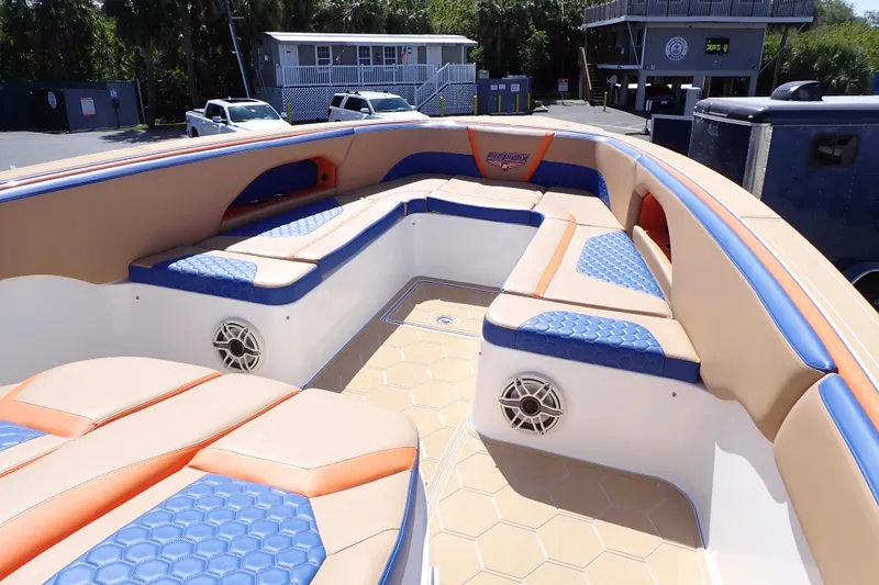 Slide: The Image of Luxurious 2022 Deep Impact 369 Sport boat interior with blue and tan seating. - 12