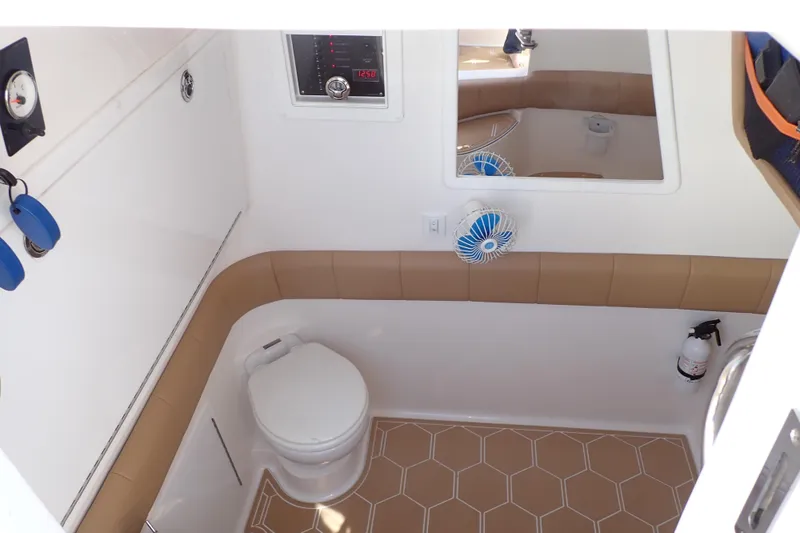 Slide: The Image of 2022 Deep Impact 369 Sport boat bathroom with toilet, fan, and fire extinguisher. - 13