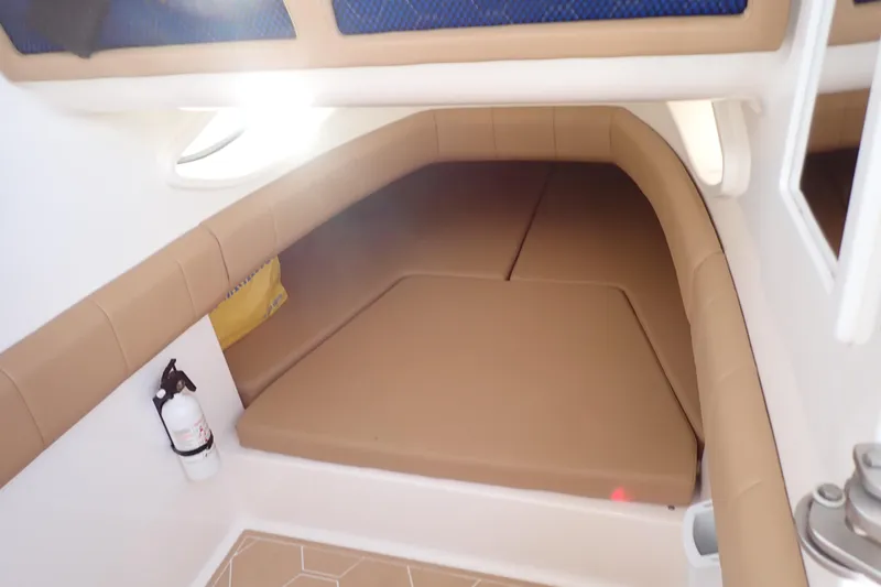 Slide: The Image of 2022 Deep Impact 369 Sport cabin interior with tan cushions and a fire extinguisher. - 14