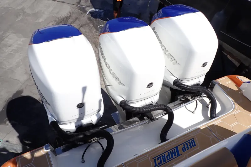 Slide: The Image of Triple Mercury outboard engines on a 2022 Deep Impact 369 Sport boat. - 16