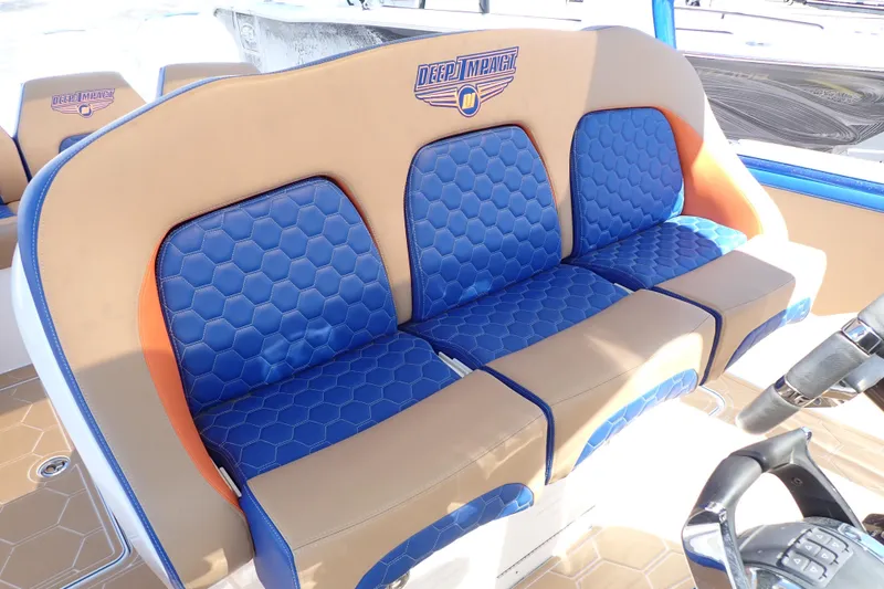 Slide: The Image of 2022 Deep Impact 369 Sport boat seats with blue hexagonal pattern and tan accents. - 19