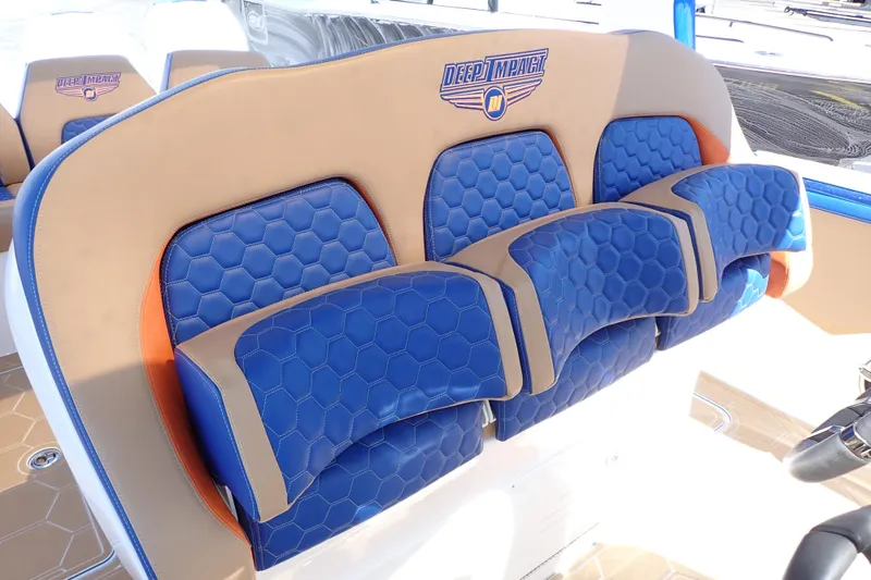 Slide: The Image of 2022 Deep Impact 369 Sport boat seats with blue and tan hexagonal pattern upholstery. - 20