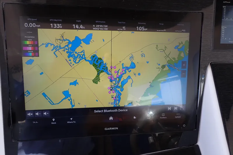 Slide: The Image of Garmin GPS display on 2022 Deep Impact 369 Sport boat, showing navigation map and data. - 23