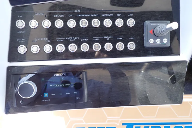 Slide: The Image of Control panel of 2022 Deep Impact 369 Sport boat with buttons and audio system. - 24