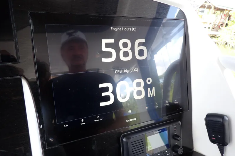 Slide: The Image of Garmin display on 2022 Deep Impact 369 Sport showing engine hours and GPS heading. - 27