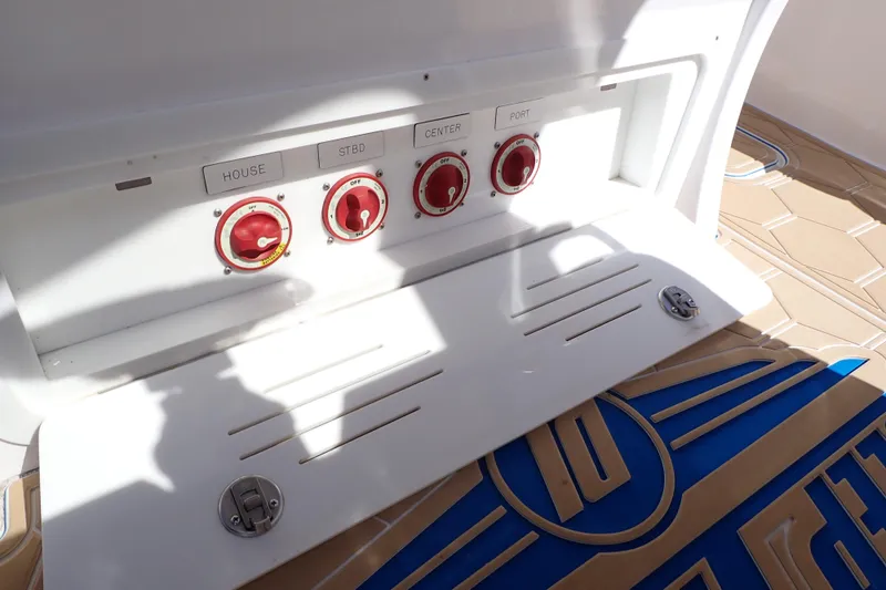 Slide: The Image of Control panel on 2022 Deep Impact 369 Sport boat with labeled switches and nautical flooring. - 31