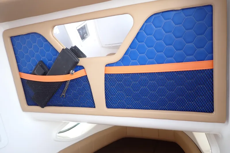 Slide: The Image of 2022 Deep Impact 369 Sport interior with blue hexagonal upholstery and storage pockets. - 32