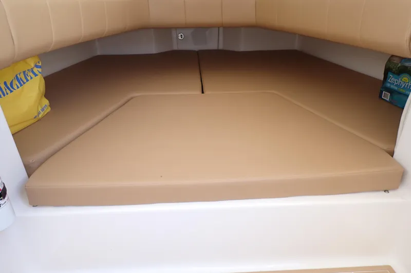 Slide: The Image of 2022 Deep Impact 369 Sport cabin interior with tan cushions and storage space. - 33