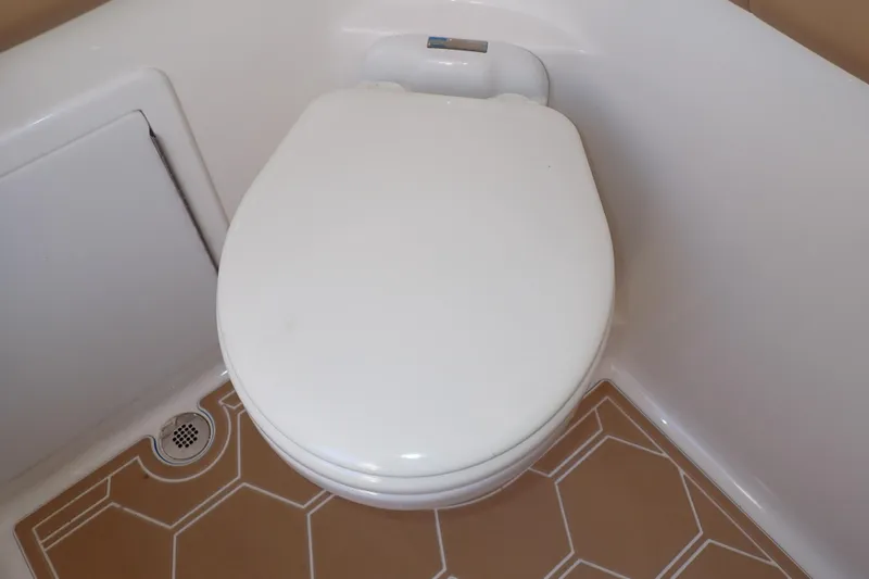 Slide: The Image of White toilet seat in a compact bathroom on a 2022 Deep Impact 369 Sport boat. - 35