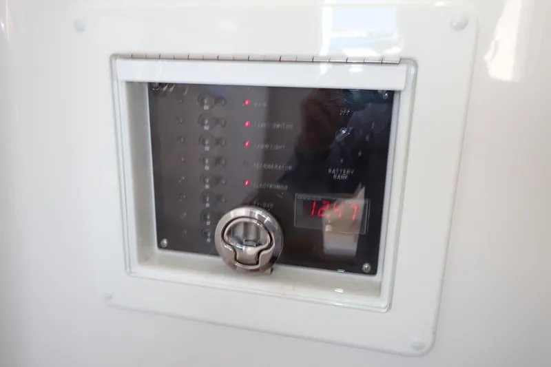 Slide: The Image of Control panel on 2022 Deep Impact 369 Sport boat, displaying digital time and switches. - 37