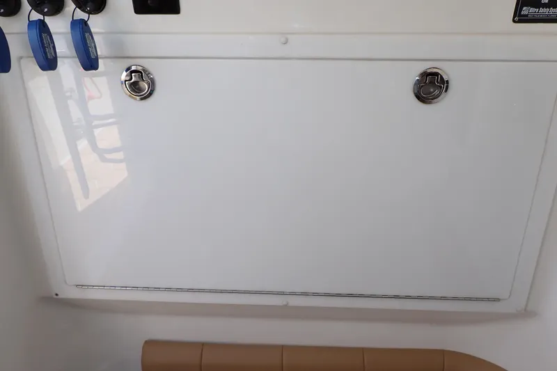 Slide: The Image of 2022 Deep Impact 369 Sport boat storage compartment with secure latches and key holders. - 40