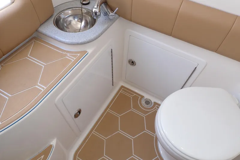 Slide: The Image of 2022 Deep Impact 369 Sport boat bathroom with sink, toilet, and tan flooring. - 42