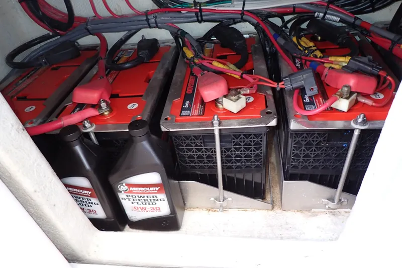 Slide: The Image of Battery compartment of 2022 Deep Impact 369 Sport with power steering fluid bottles. - 44