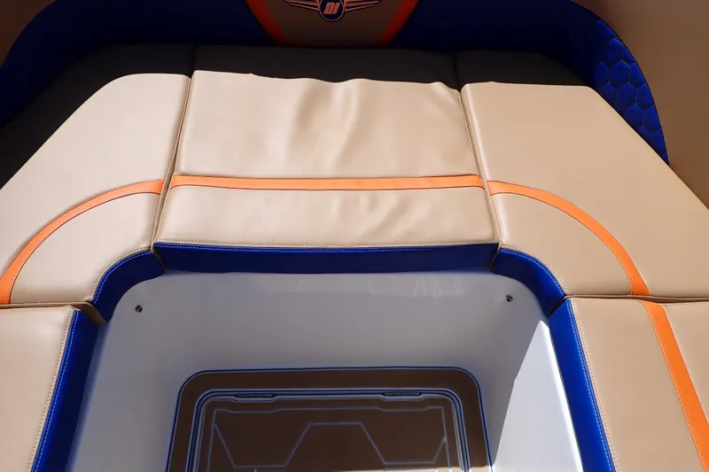 Slide: The Image of 2022 Deep Impact 369 Sport boat interior with beige, blue, and orange cushioned seating. - 48