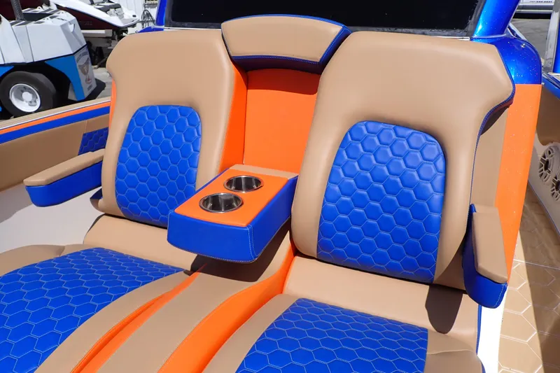 Slide: The Image of 2022 Deep Impact 369 Sport boat seats with blue and orange hexagonal pattern and cup holders. - 58