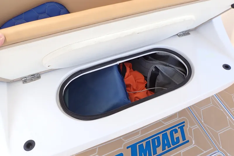 Slide: The Image of Storage compartment on 2022 Deep Impact 369 Sport boat, featuring gear and accessories. - 64