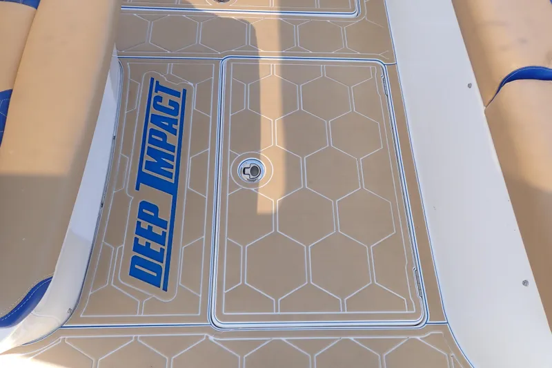 Slide: The Image of Deck of 2022 Deep Impact 369 Sport boat with hexagonal pattern and logo. - 67
