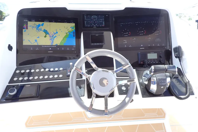 Slide: The Image of 2022 Deep Impact 369 Sport boat dashboard with navigation screens and controls. - 7