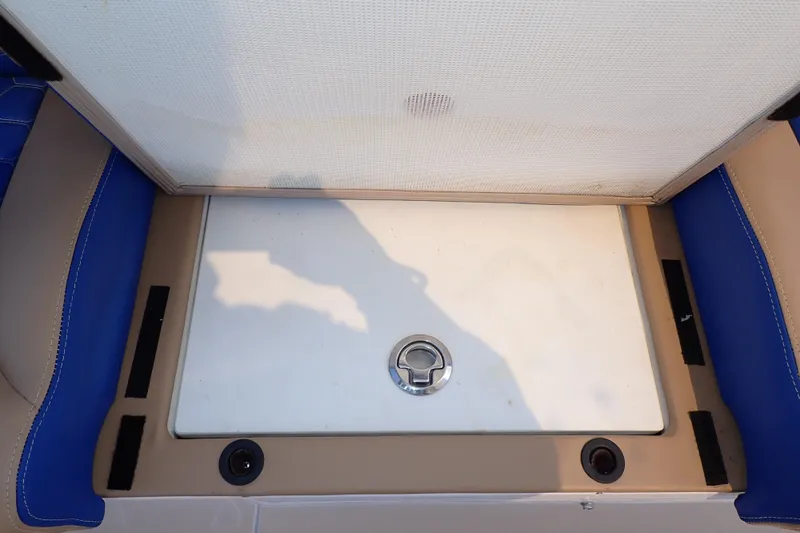 Slide: The Image of Open storage compartment on 2022 Deep Impact 369 Sport boat with blue and tan seating. - 72