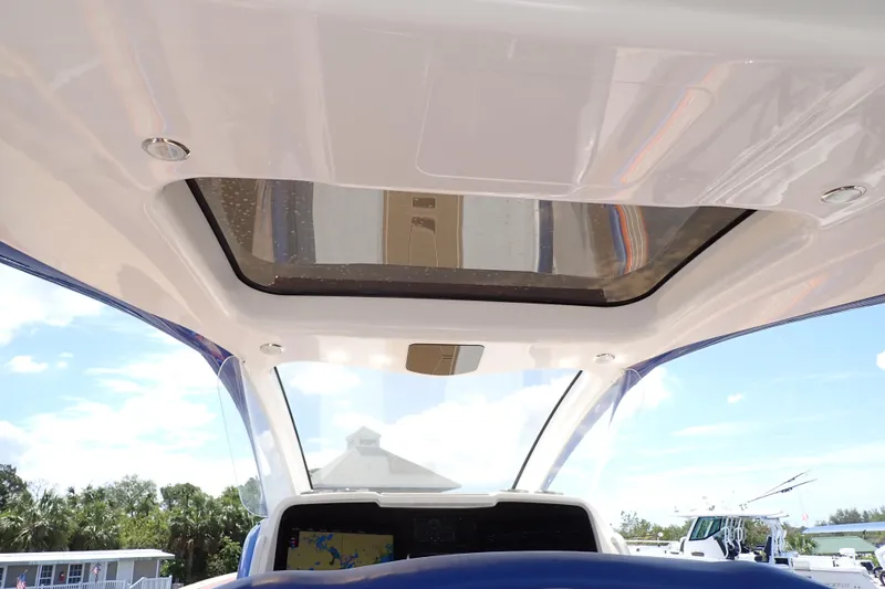 Slide: The Image of Interior view of 2022 Deep Impact 369 Sport boat with sunroof and navigation display. - 75