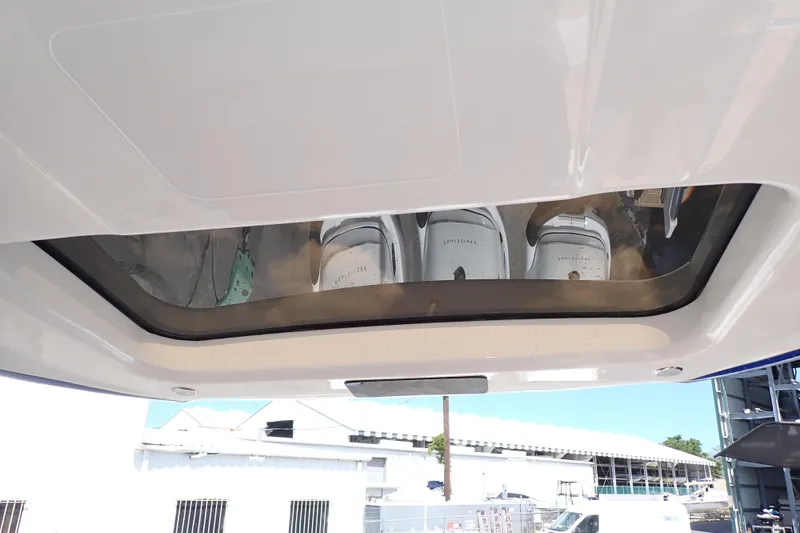 Slide: The Image of 2022 Deep Impact 369 Sport boat with visible engines through a glass panel. - 76