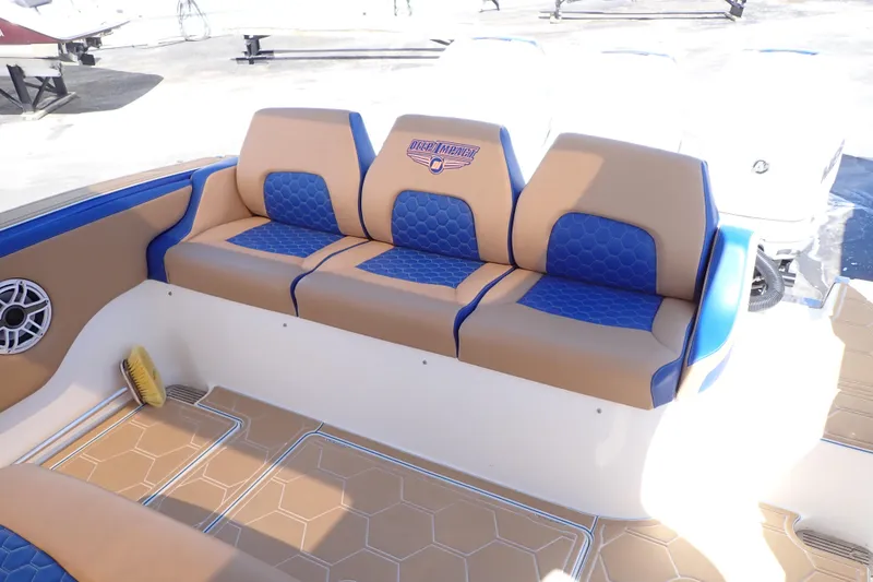 Slide: The Image of Luxurious seating on 2022 Deep Impact 369 Sport boat, featuring blue and tan upholstery. - 8