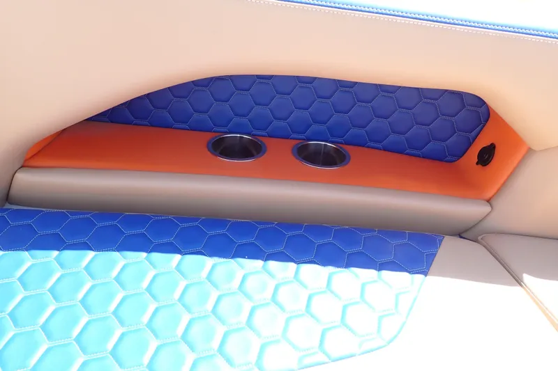 Slide: The Image of 2022 Deep Impact 369 Sport interior with blue hexagonal upholstery and dual cup holders. - 83