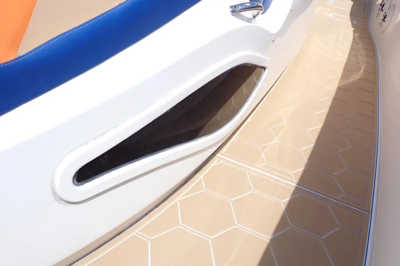 Slide: The Image of 2022 Deep Impact 369 Sport boat deck with blue and orange seating, beige flooring. - 86