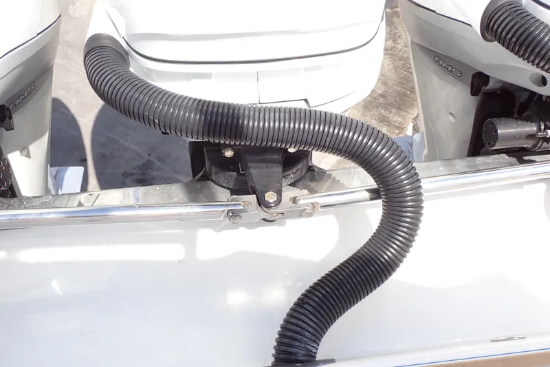 Slide: The Image of 2022 Deep Impact 369 Sport boat engine detail with black hose and metal fittings. - 88