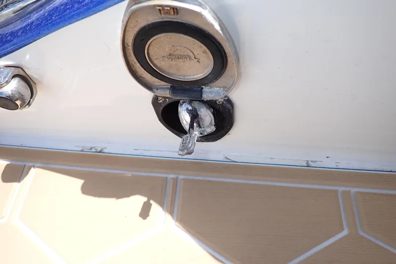 Slide: The Image of Fuel cap of a 2022 Deep Impact 369 Sport boat, showing key inserted. - 91
