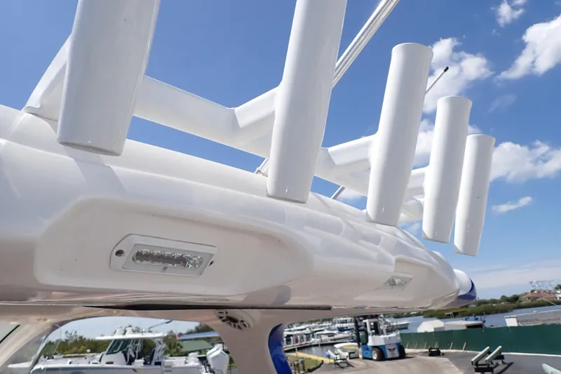 Slide: The Image of Close-up of 2022 Deep Impact 369 Sport boat's rod holders and lights against a blue sky. - 92