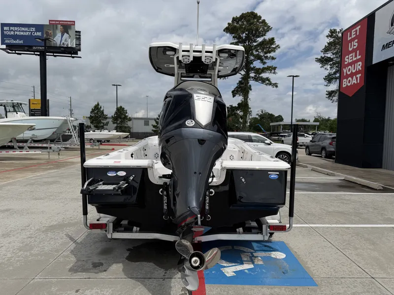 Slide: The Image of Rear view of a 2026 Tidewater 2210 Carolina Bay boat in a parking lot. - 32