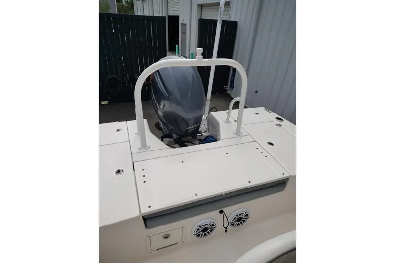 Slide: The Image of 2021 Robalo 226 Cayman boat with outboard motor and rear deck view. - 10