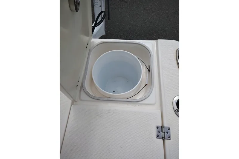 Slide: The Image of Livewell compartment on a 2021 Robalo 226 Cayman boat, featuring a white interior. - 11