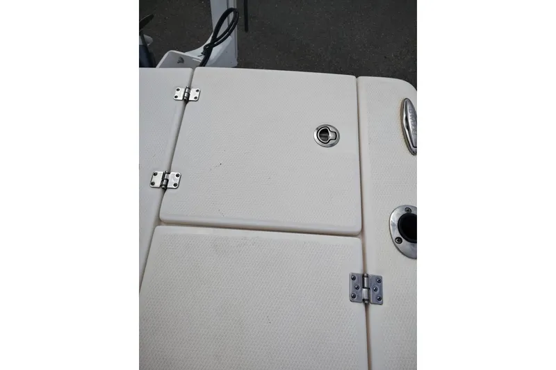 Slide: The Image of 2021 Robalo 226 Cayman boat deck with storage hatch and hardware. - 12