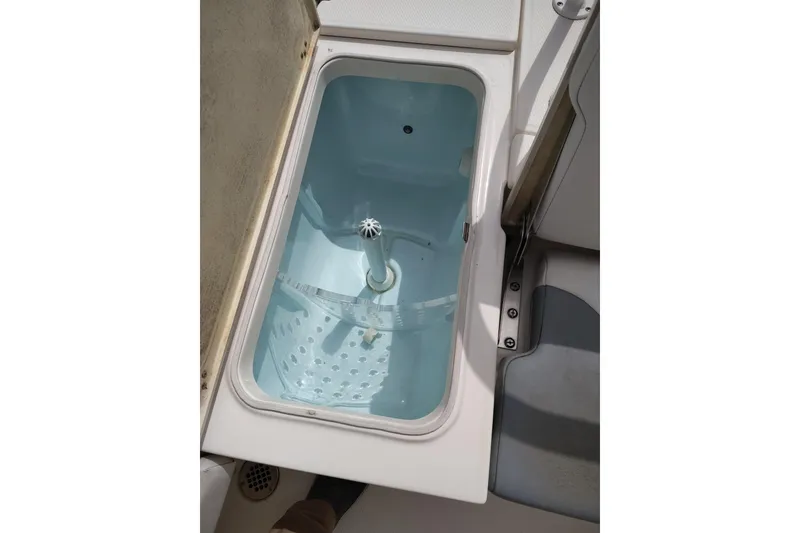 Slide: The Image of Livewell compartment on a 2021 Robalo 226 Cayman boat, open and empty. - 15