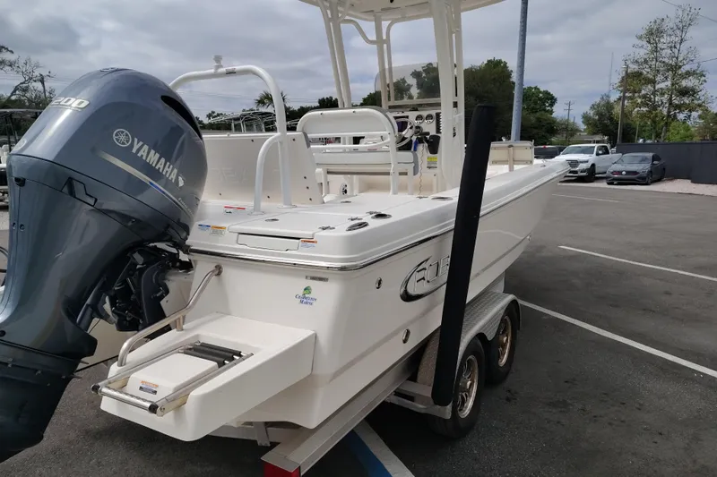 Slide: The Image of 2021 Robalo 226 Cayman boat with Yamaha engine on trailer in parking lot. - 2