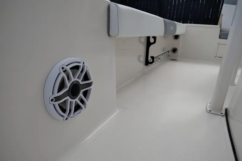 Slide: The Image of 2021 Robalo 226 Cayman boat interior with speaker and rod holder. - 20